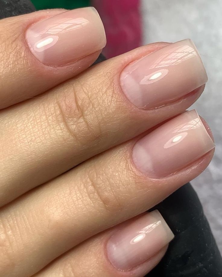 Close-up of a clean hard gel overlay on square natural nails with a milky finish.