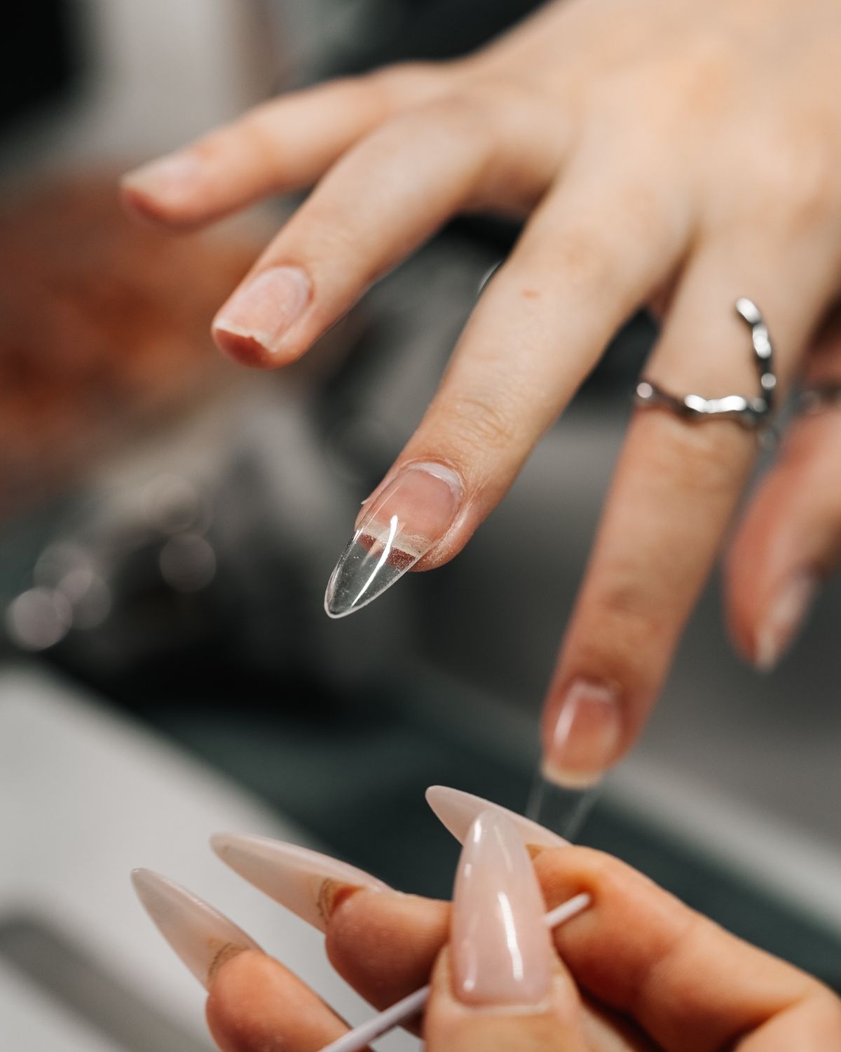 A finished Gel X manicure with a natural, sculpted almond shape.