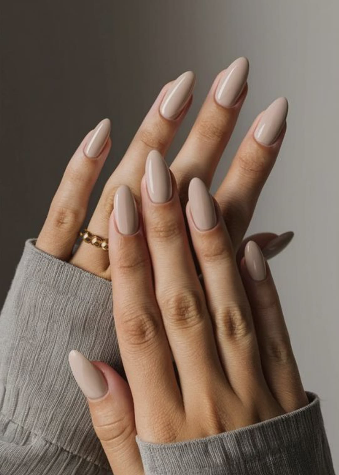 Sheer nude-tone manicure on natural-shape nails.